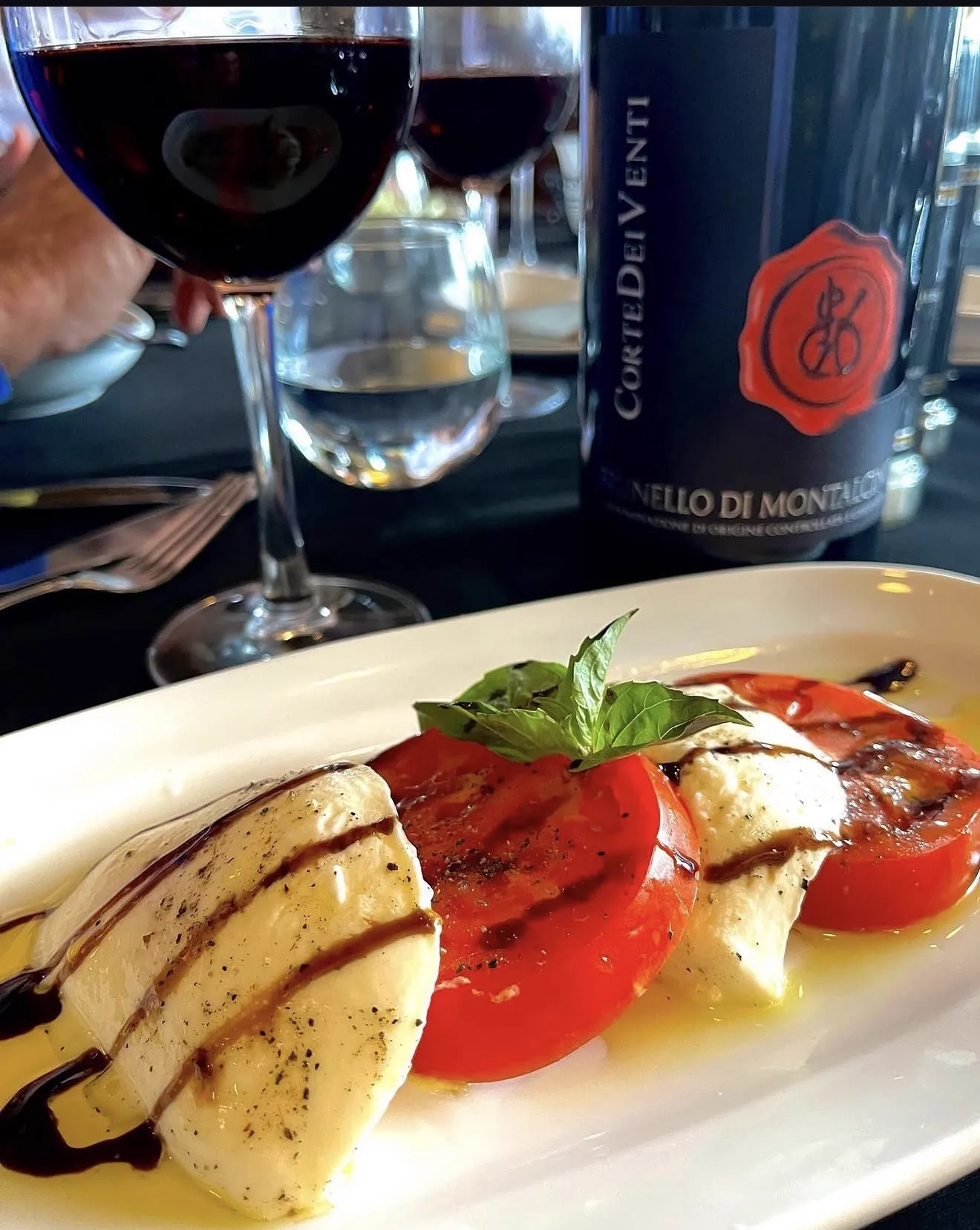 Caprese salad paired with Italian wine at Ciao Italia private dining