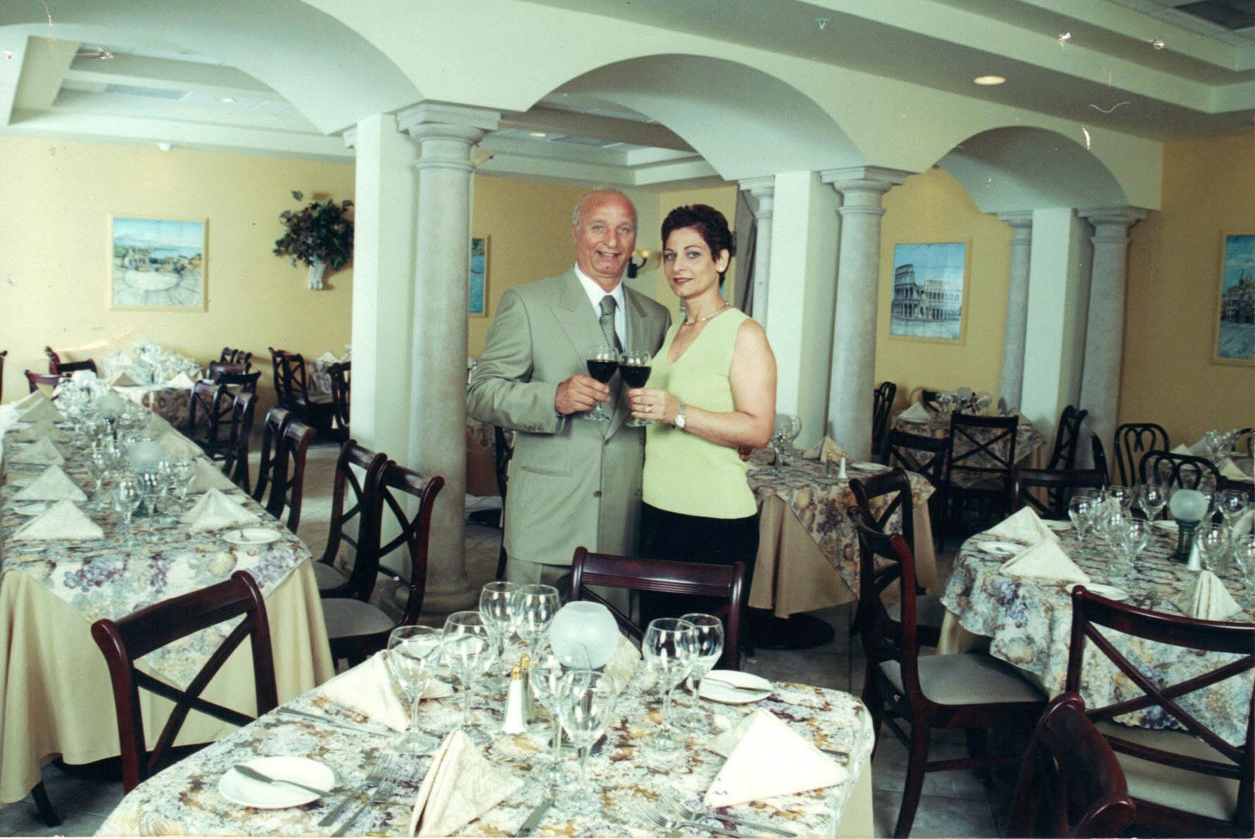 Antonio and Josie Navarra toasting in the Ciao Italia dining room